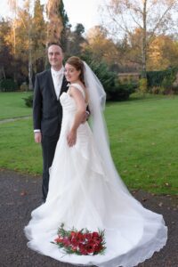 Bride and groom with Bird's bouquet on her train